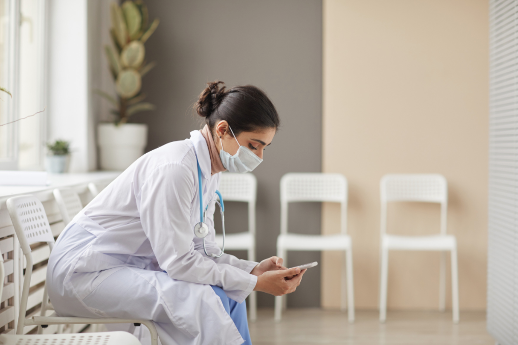 Physician looking at mobile device